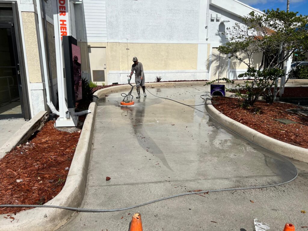 Clean pool deck and driveway outside Pompano Beach home after professional exterior washing